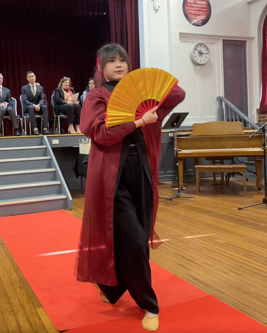 Female student performs fan dance
