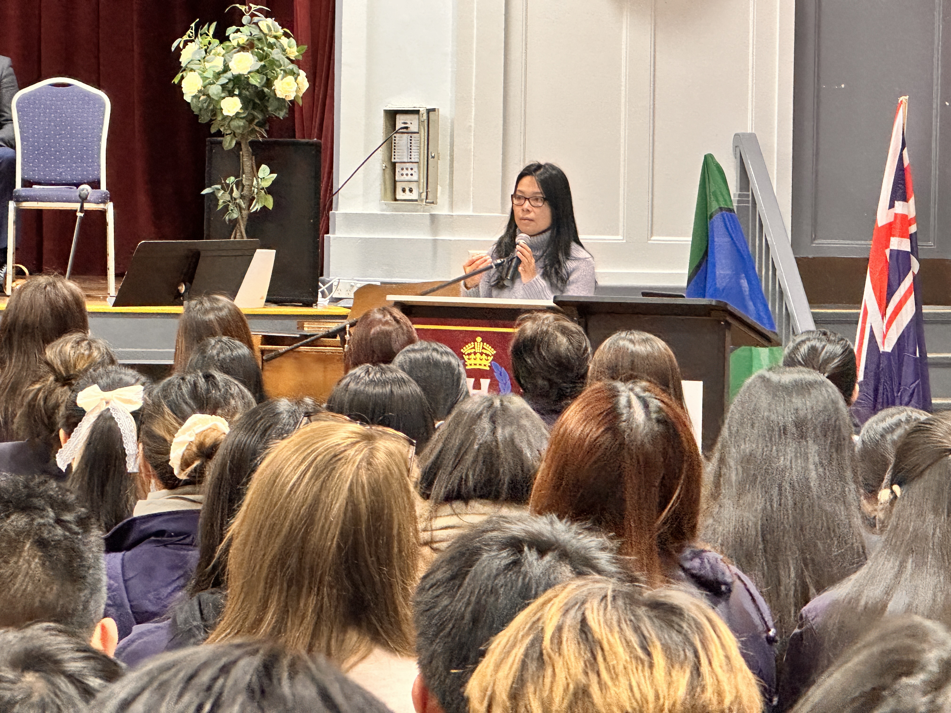 A female adult speaks to a student audience